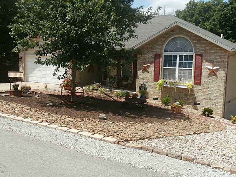 Exterior Front. Beautiful landscaped front yard.