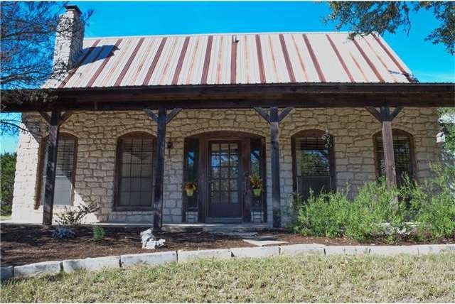 Front of house with expansive covered patio... Full of Texas Hill Country charm!