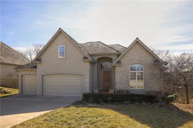 EXTERIOR ALL STUCCO AND STONE SITTING ON A TREED W