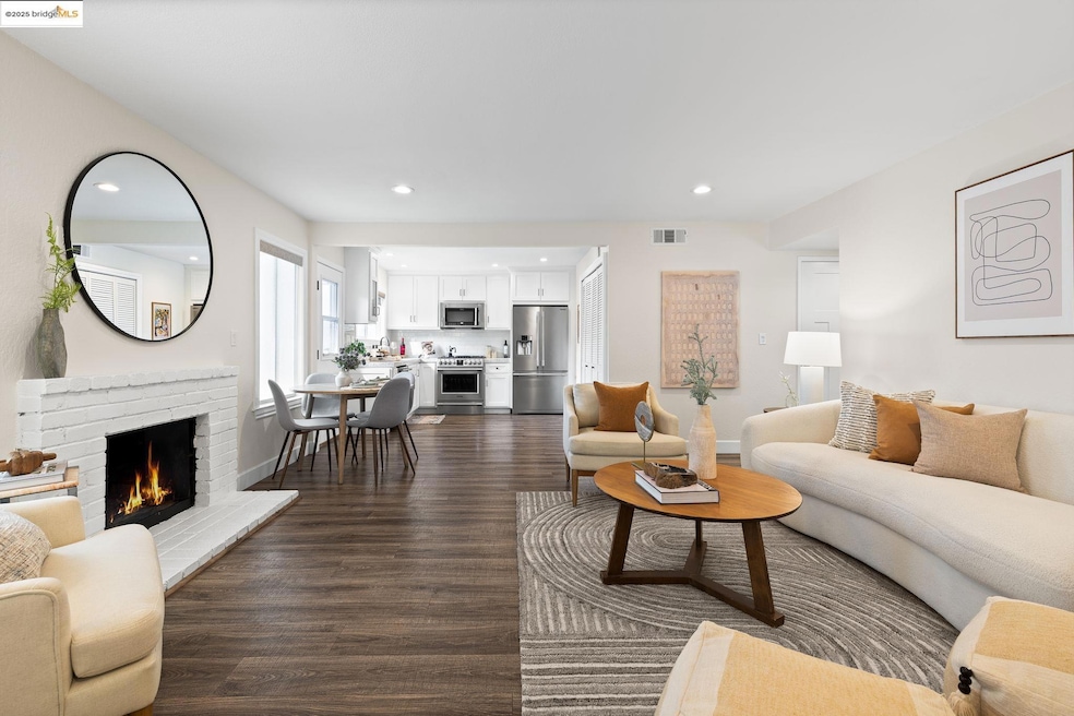 Living area with recessed lighting, dark wood-style floors, and a brick fireplace