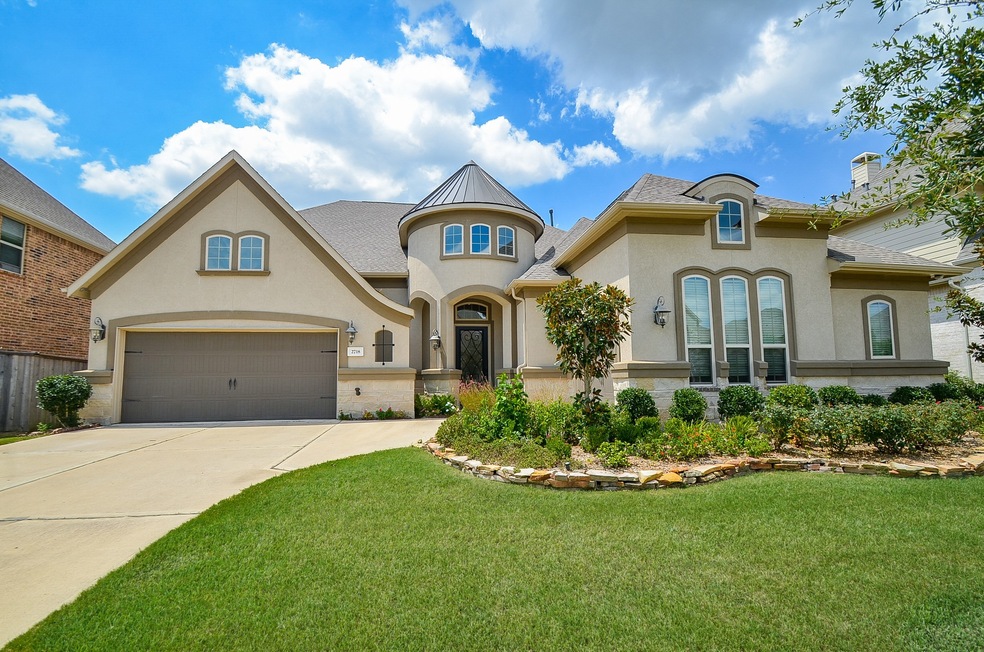This exquisitely manicured property, inside and out, is located at 2718 Dogwood Terrace Lane, Katy, TX, in the desirable Cinco Ranch Northwest community. Precision artistic native landscaping shows proud ownership and curb appeal to the max! Seen here are the garages (4-tandem) and the home's pristine, expansive driveway. This is a great feature for vistors' vehicles!