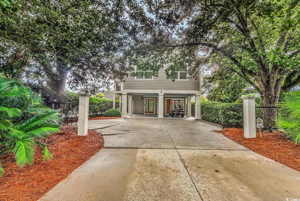 View of front of home featuring a carport and concrete driveway