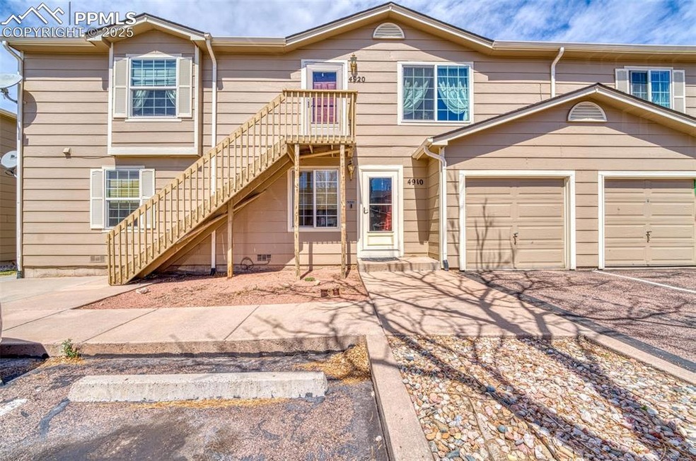 Multi unit property with driveway, a garage, and stairs
