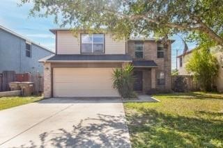 View of front property with a front yard and a garage