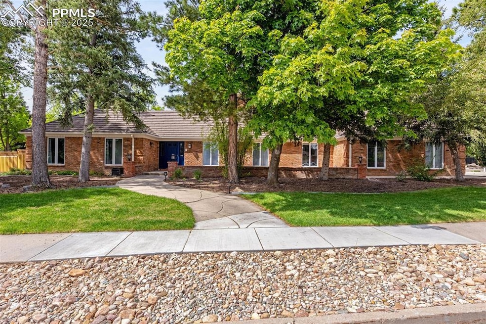 Single story home featuring a front lawn and brick siding