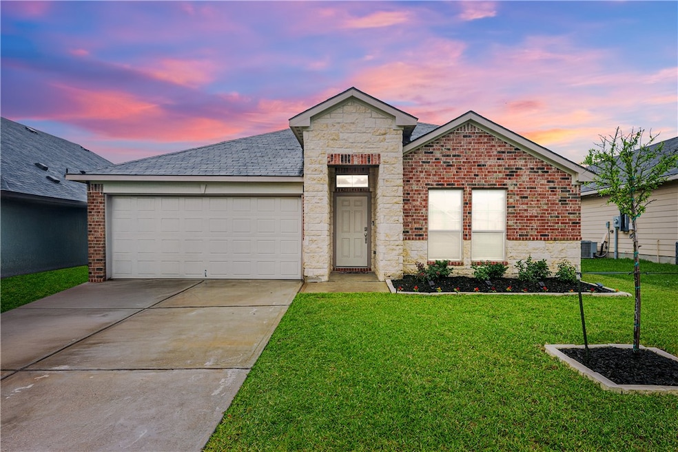 View of front of home featuring a yard, driveway,