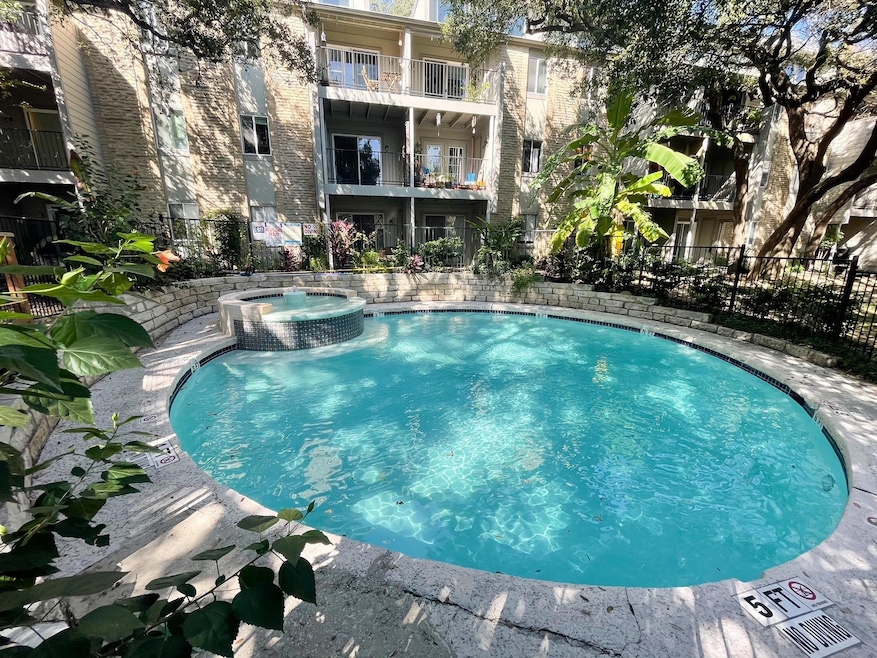 View of pool featuring a pool with connected hot 