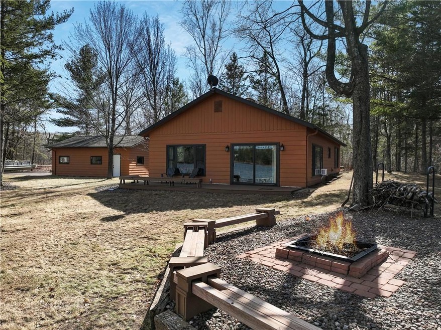 Lakeside of home with firepit area.