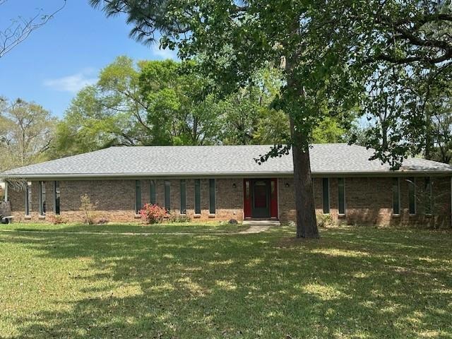 Single story home with a front lawn