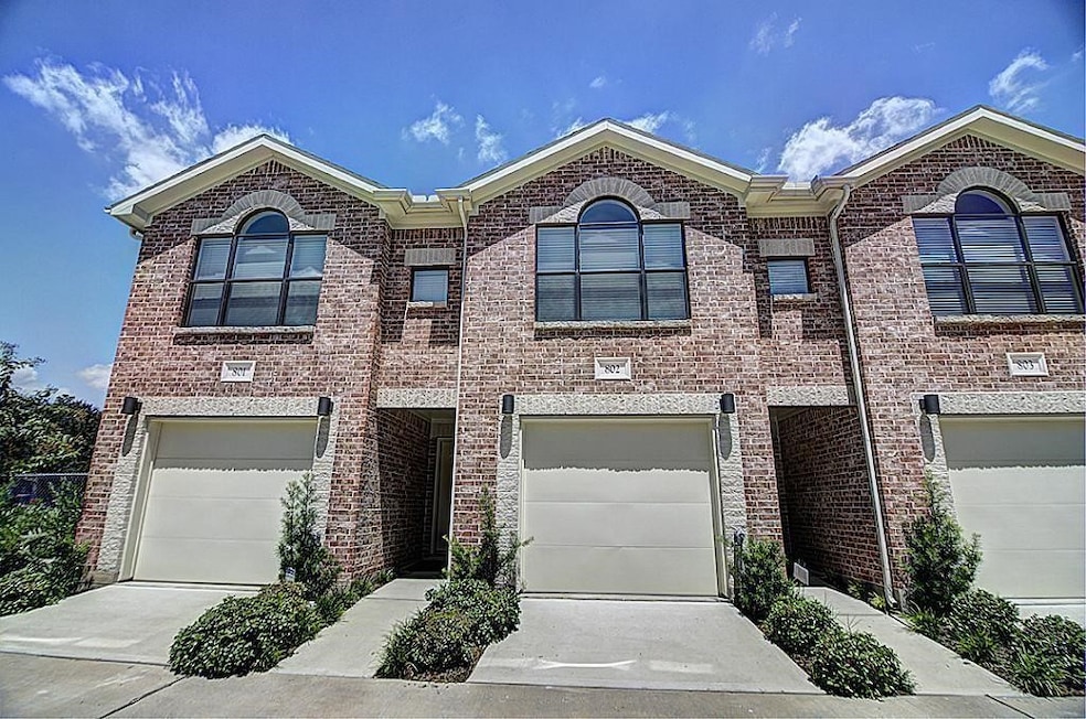 This photo shows a modern, two-story brick townhou