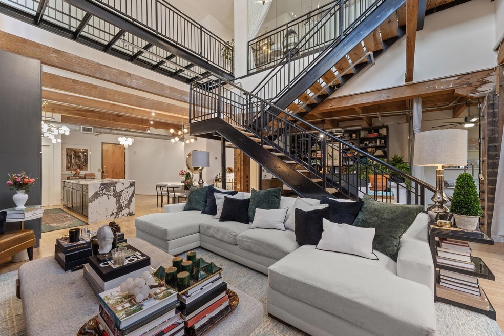 Living room featuring a high ceiling, wood finishe