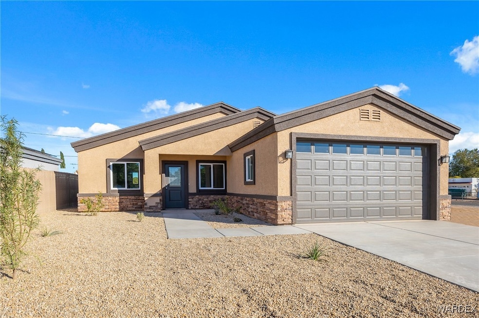 Single story home featuring a garage, concrete dri