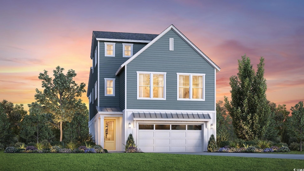 Front of property featuring a lawn and a garage