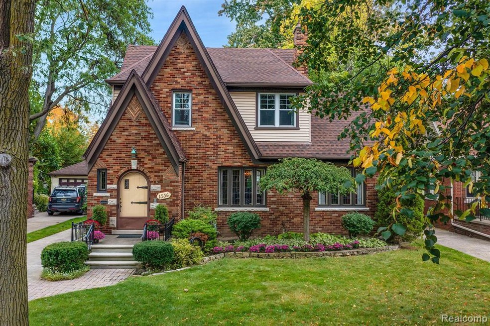 Beautiful landscaping on this brick Tudor home
