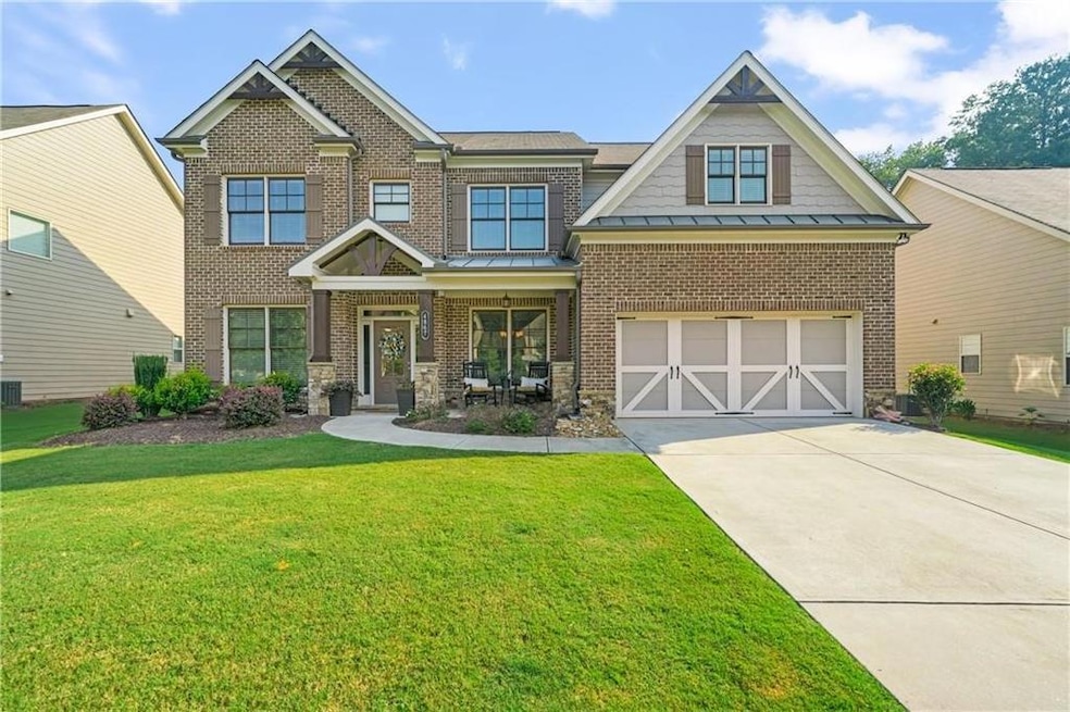 Craftsman-style home with a garage and a front yar