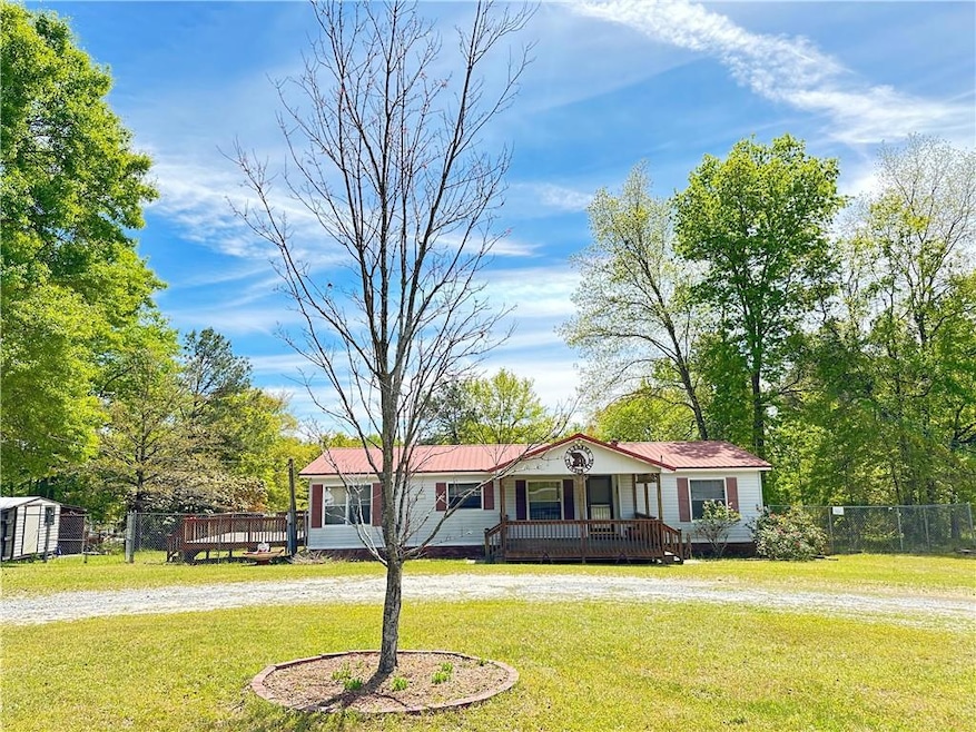 View of front of property featuring a wooden deck,