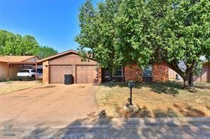 View of front of home featuring a garage and concr
