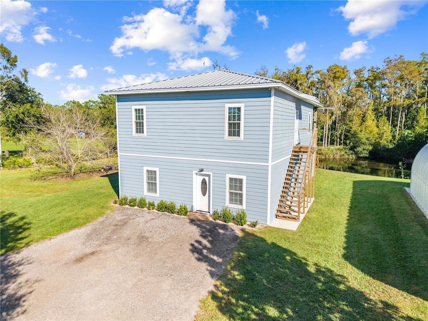Main house front view. Stairs on side to Mud room.