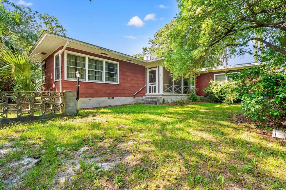 View of front of home featuring a front yard, crawl space, a sunroom, and a chimney