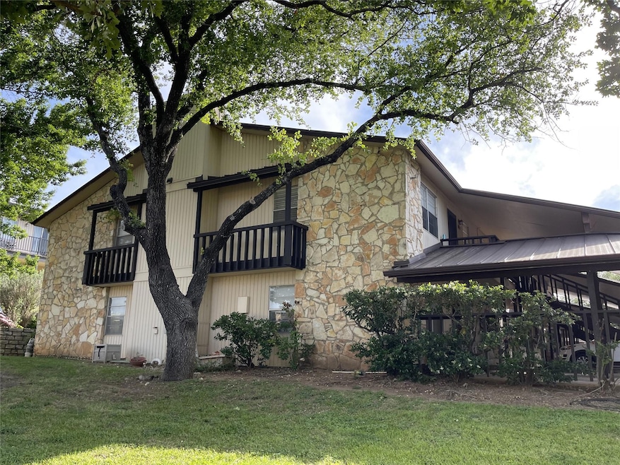 View of home's exterior featuring a yard, stone s