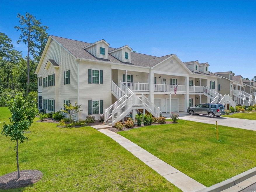 View of front of house featuring a garage, stairs, concrete driveway, and a front yard