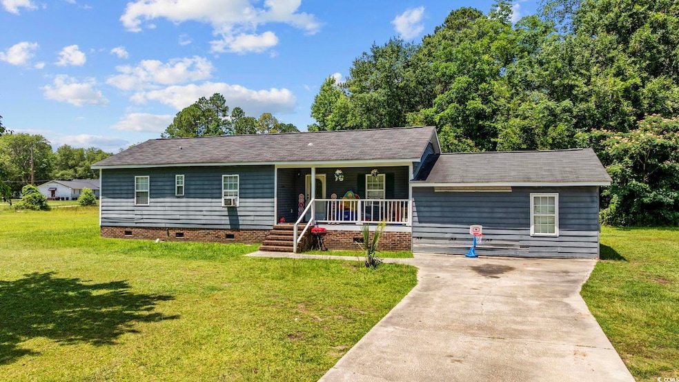 Ranch-style home with crawl space, covered porch, a front yard, driveway, and roof with shingles
