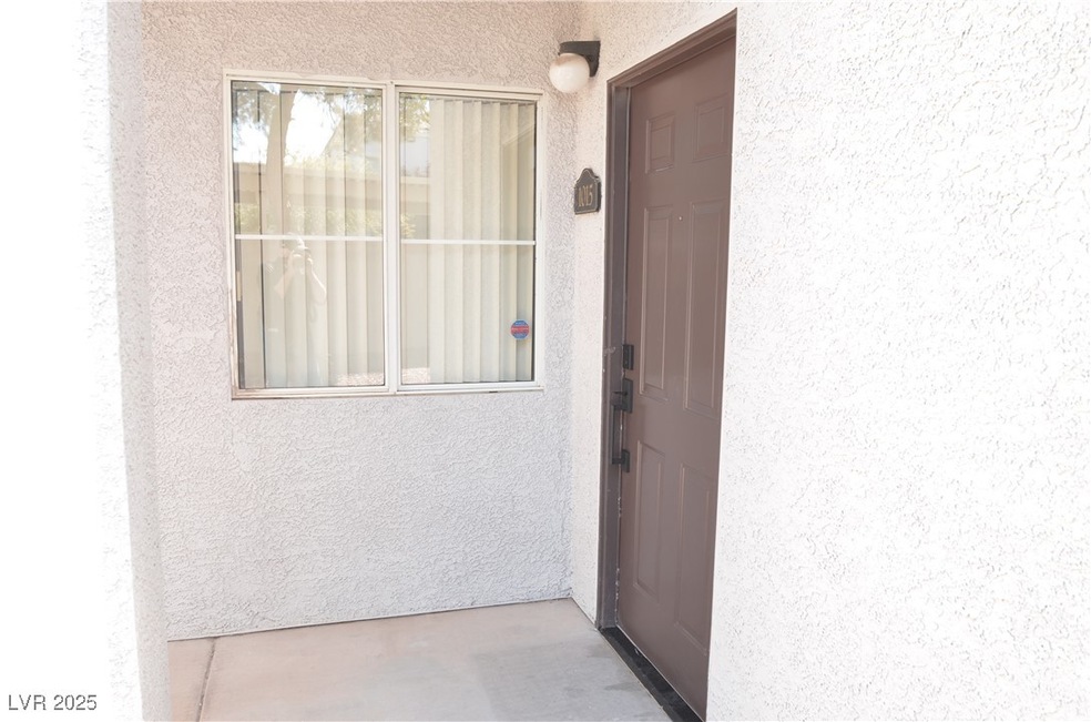 Entrance to property with stucco siding