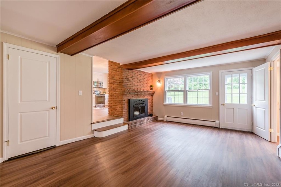 Spacious Sunken Family Room with wood beams, firep