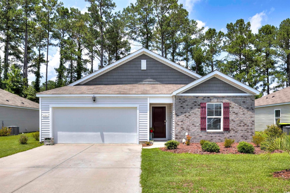 View of front of home with a garage, central AC, a
