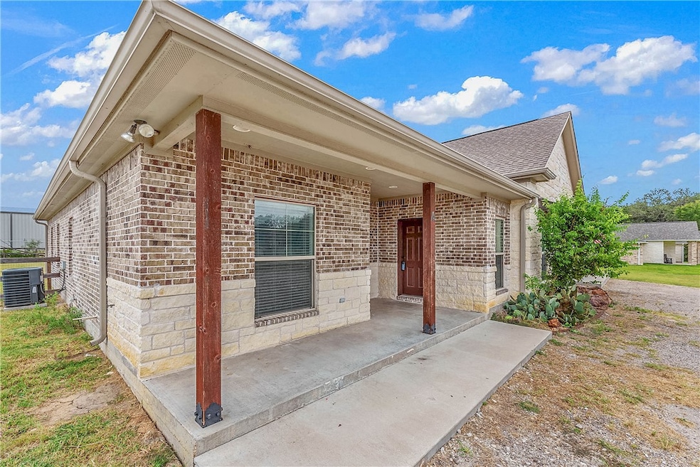 Property entrance with stone siding, brick siding,