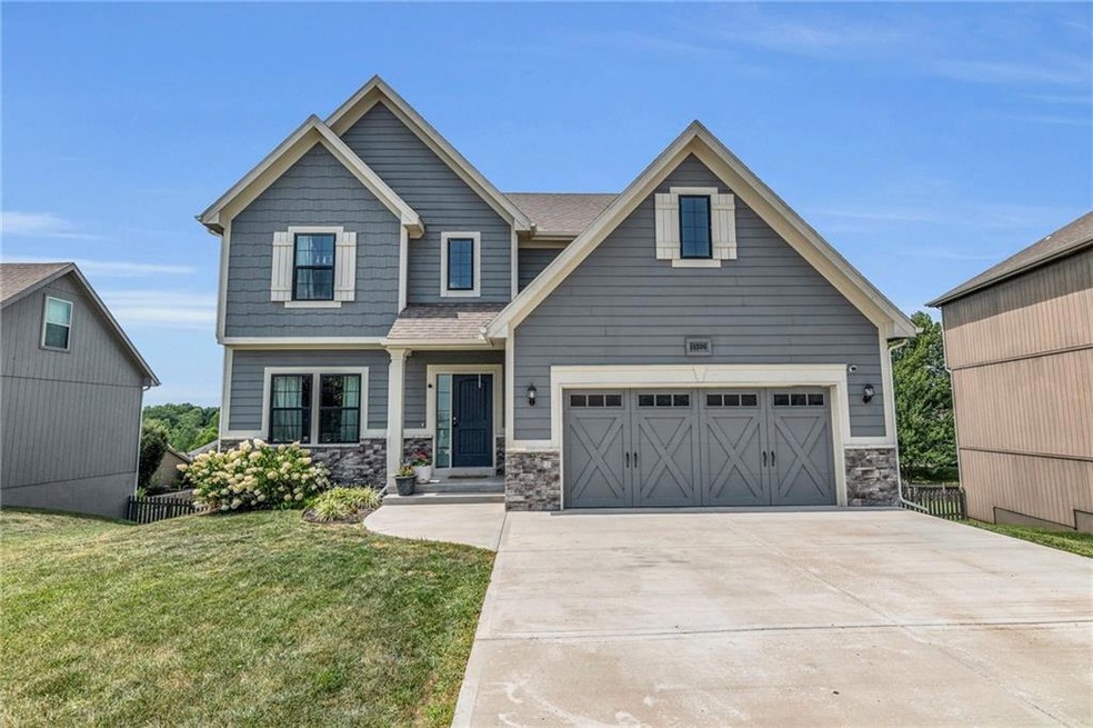 Craftsman-style house featuring a garage and a front yard