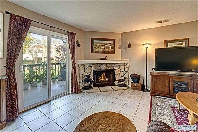 Living room with fireplace and balcony.