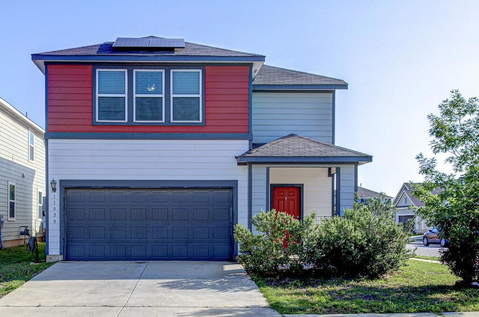 View of front facade with a garage, solar panels,