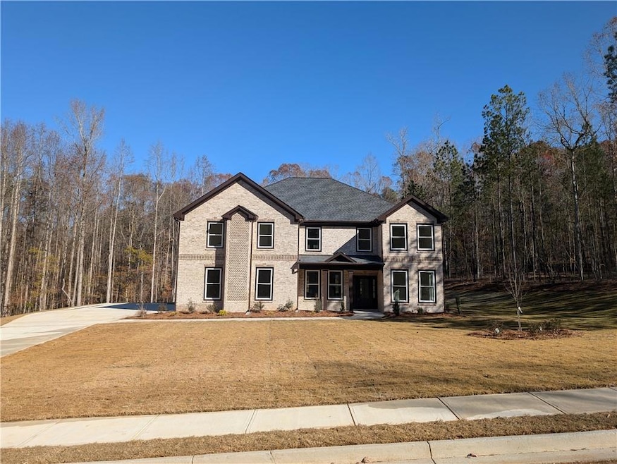 View of front of home with driveway, a front yard,