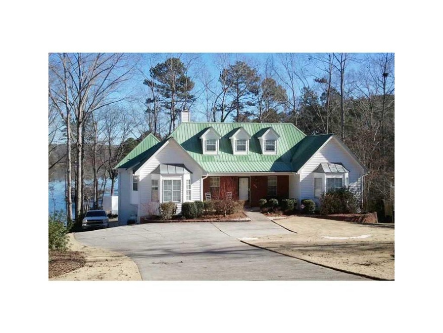 Exterior Front. Lake is right behind the house! Be