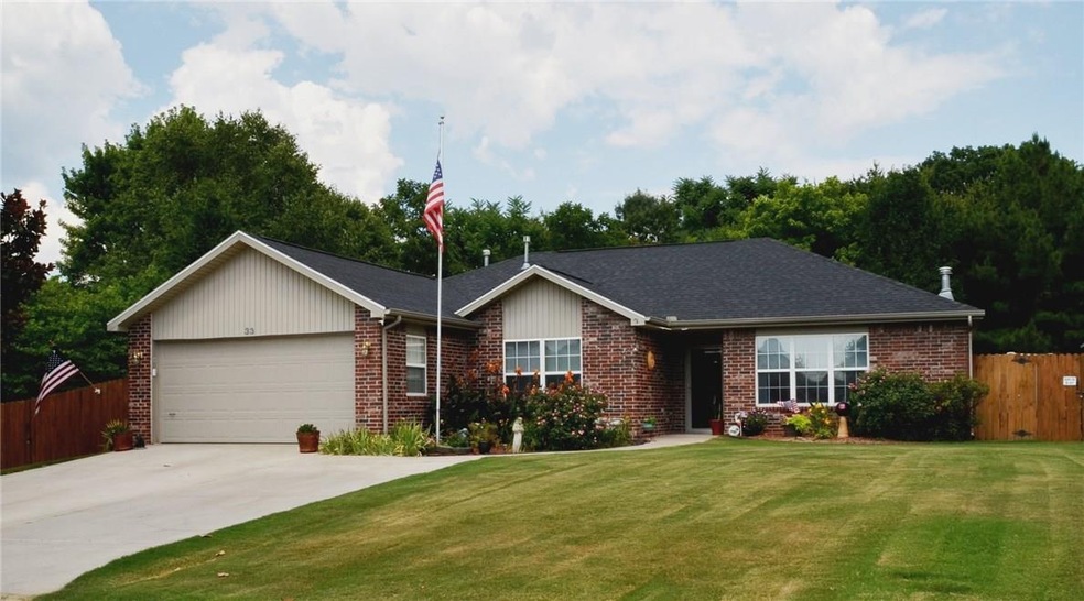 Beautiful landscaping accents the front of this all brick home.