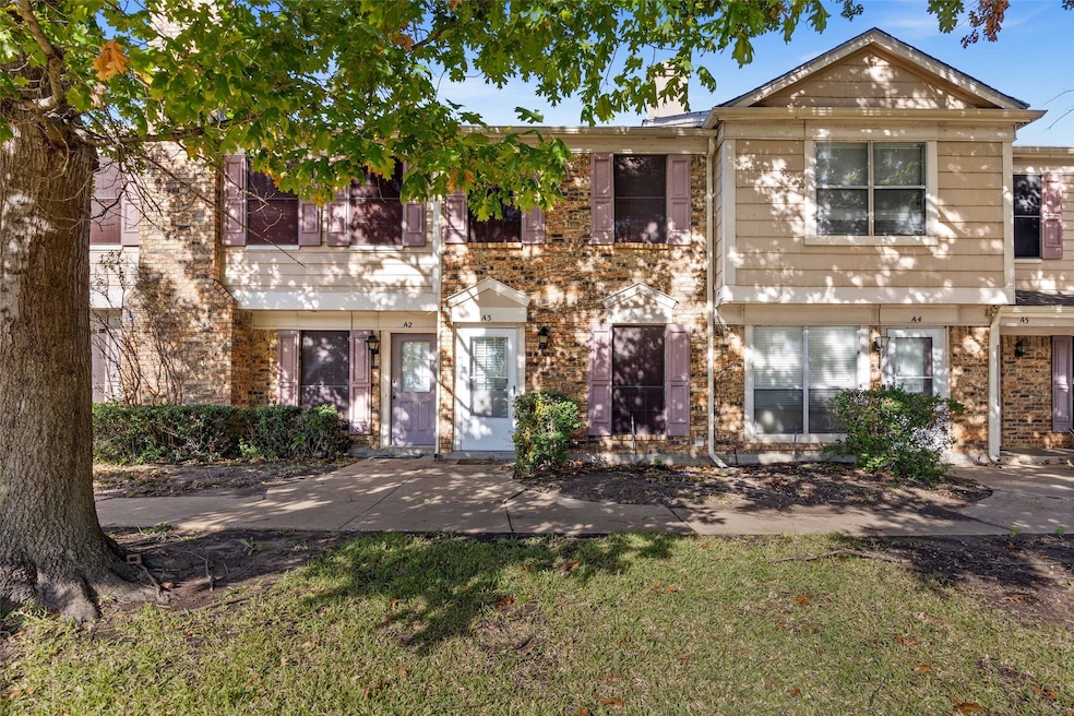 View of front of home featuring a front lawn and brick siding