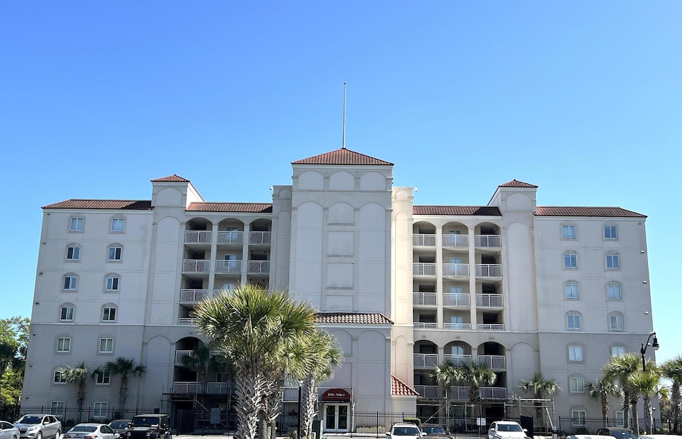 View of property with uncovered parking