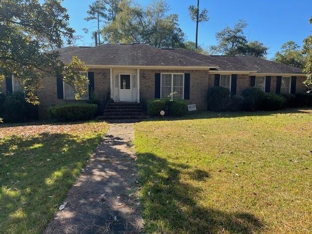 Ranch-style home with a front lawn