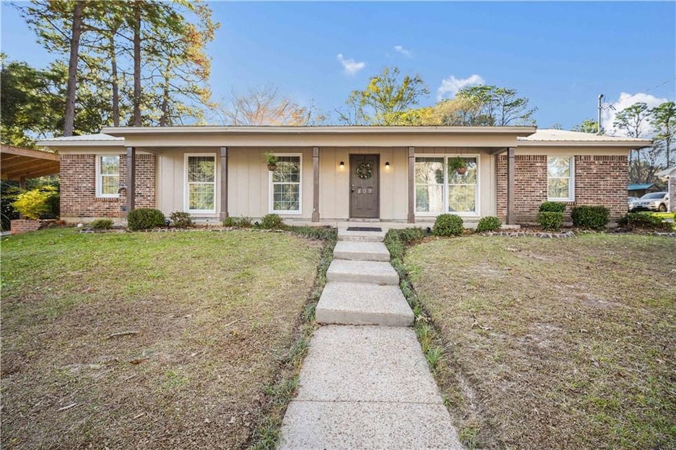Ranch-style home featuring a front yard