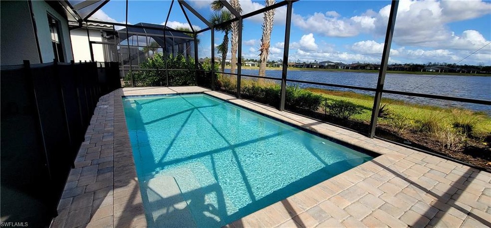 View of pool with a lanai and a water view