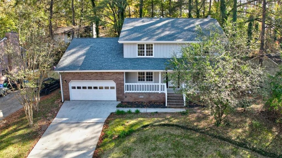 View of front facade featuring a garage, a front l