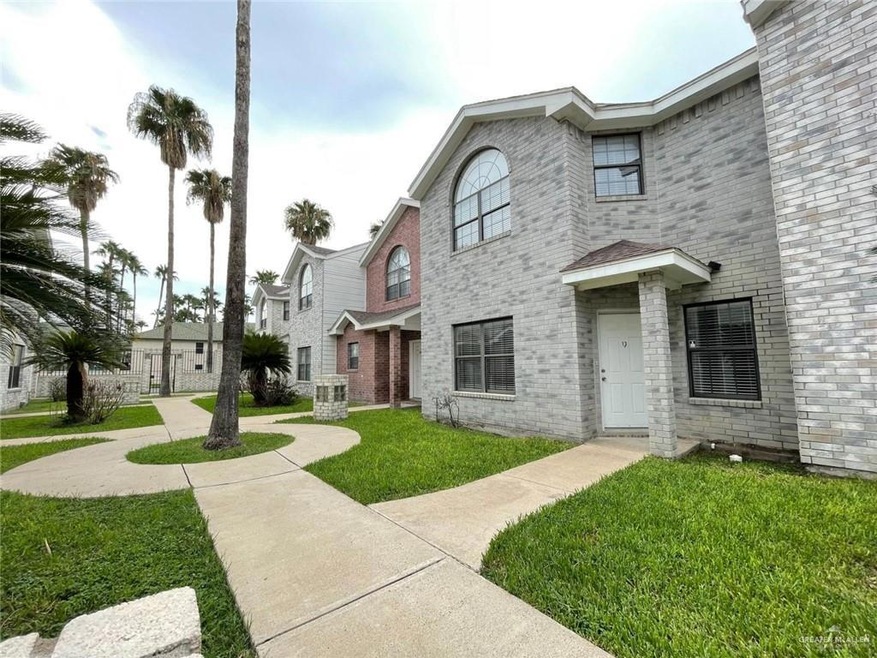 View of front facade with central AC and a front yard