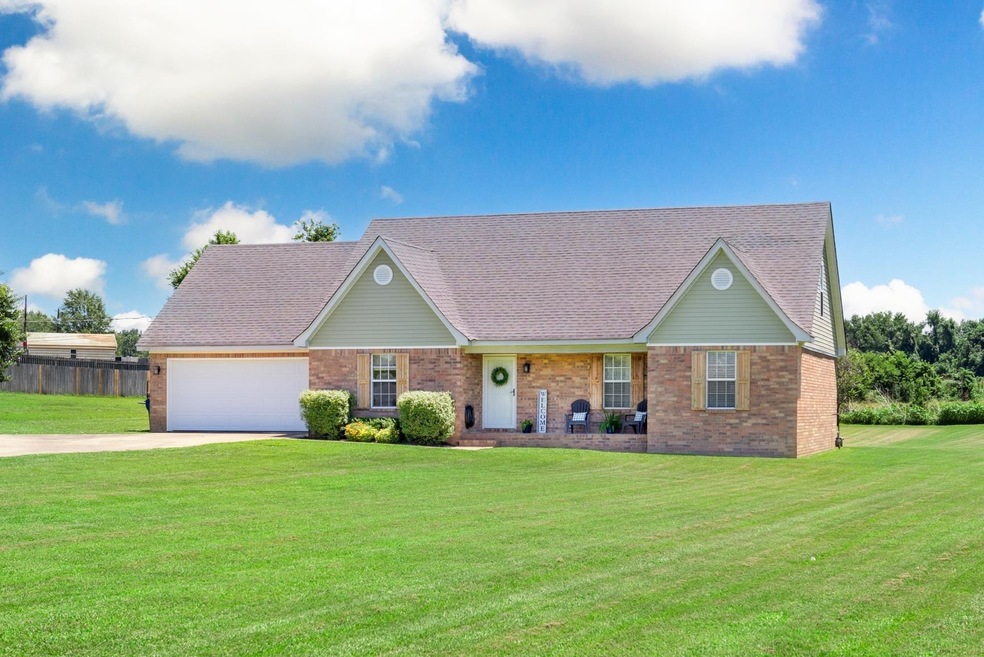 Single story home featuring a garage and a front l