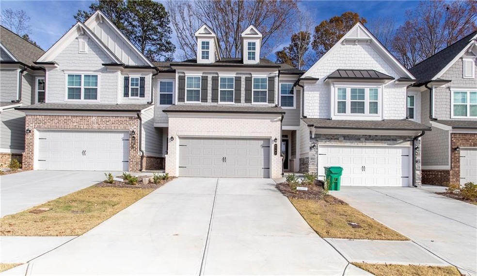 Townhome / multi-family property featuring a garag