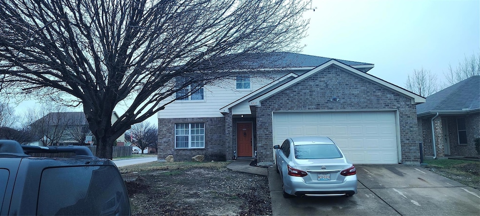 Traditional home with concrete driveway, brick sid
