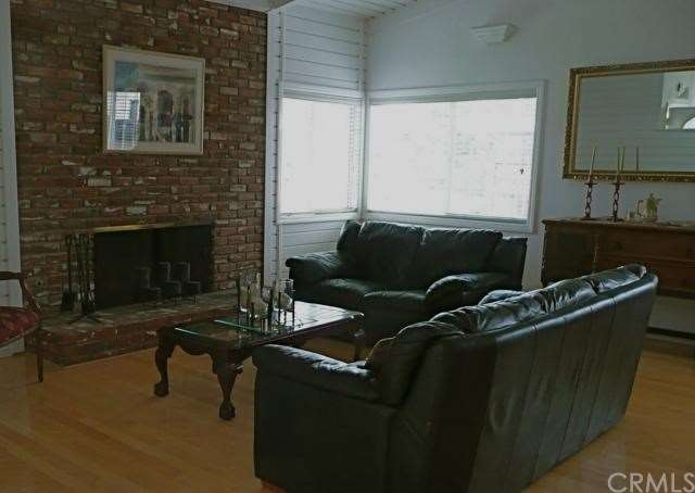 Fireplace with raised hearth is focal point of thi