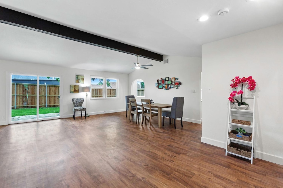 Dining area featuring dark wood-type flooring, ba