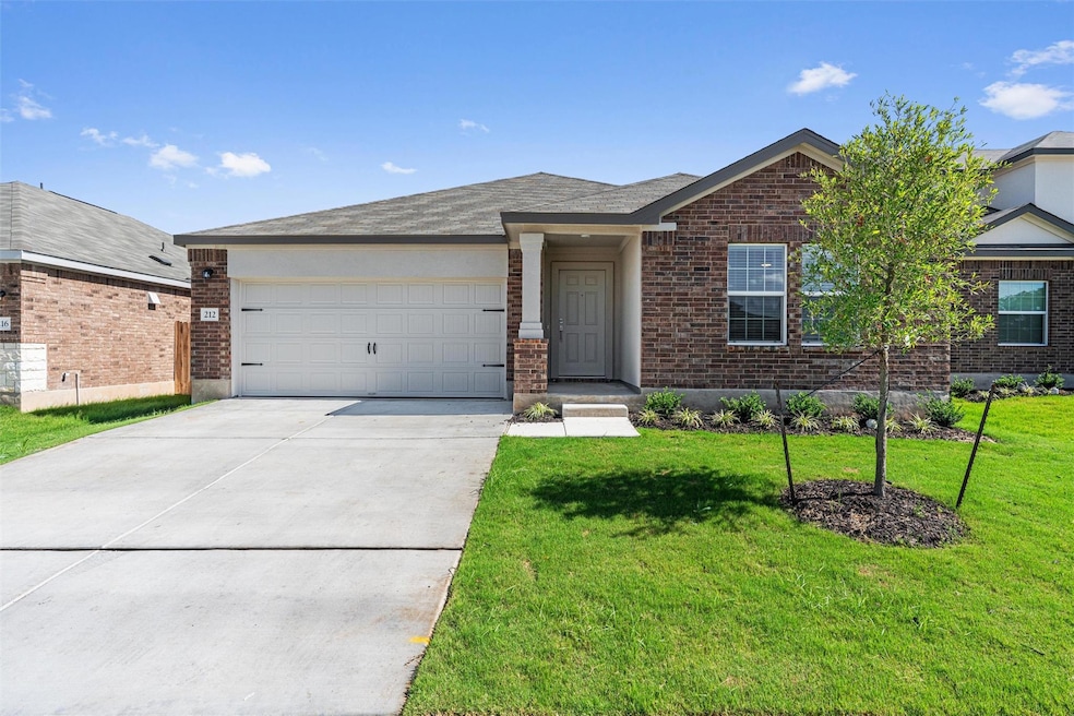 Ranch-style home with brick siding, an attached g