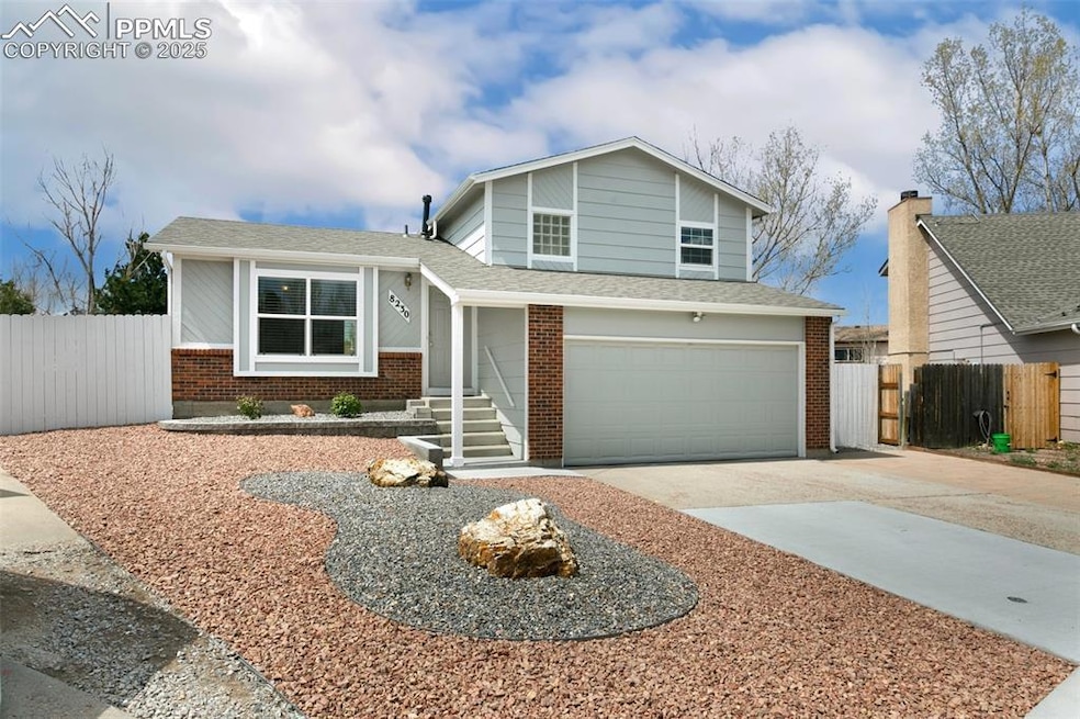 Split level home with driveway, fence, an attached